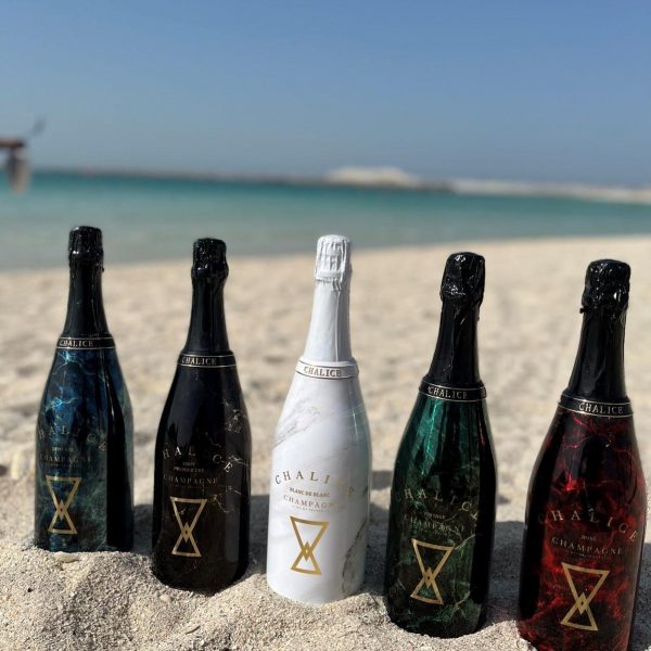 Premium Chalice bottles stand in the sand